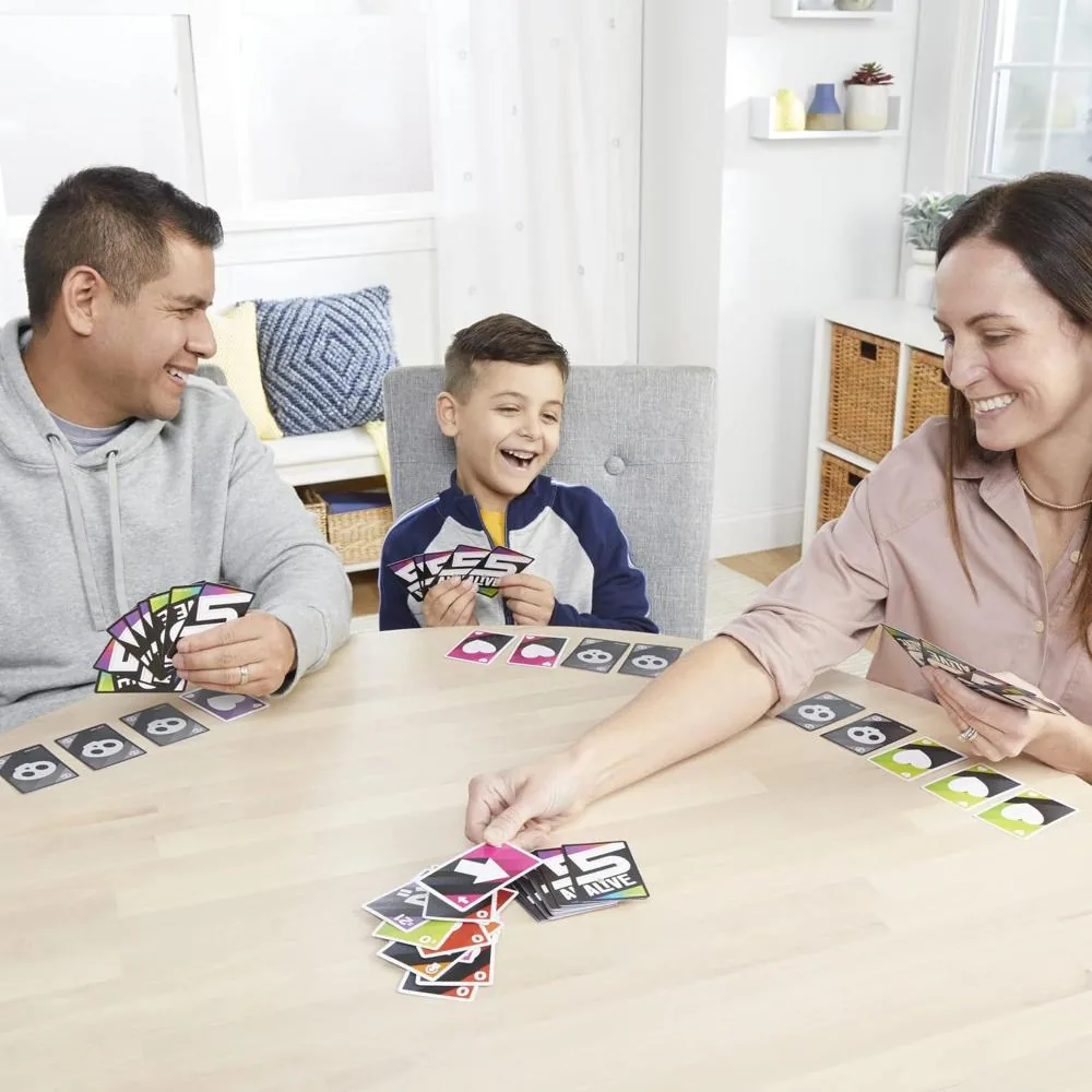 A father, mother and son around a table playing 5 Alive