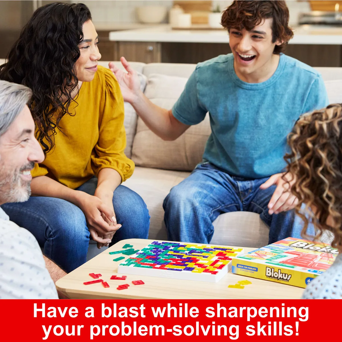 A family playing Blokus on a sofa, laughing