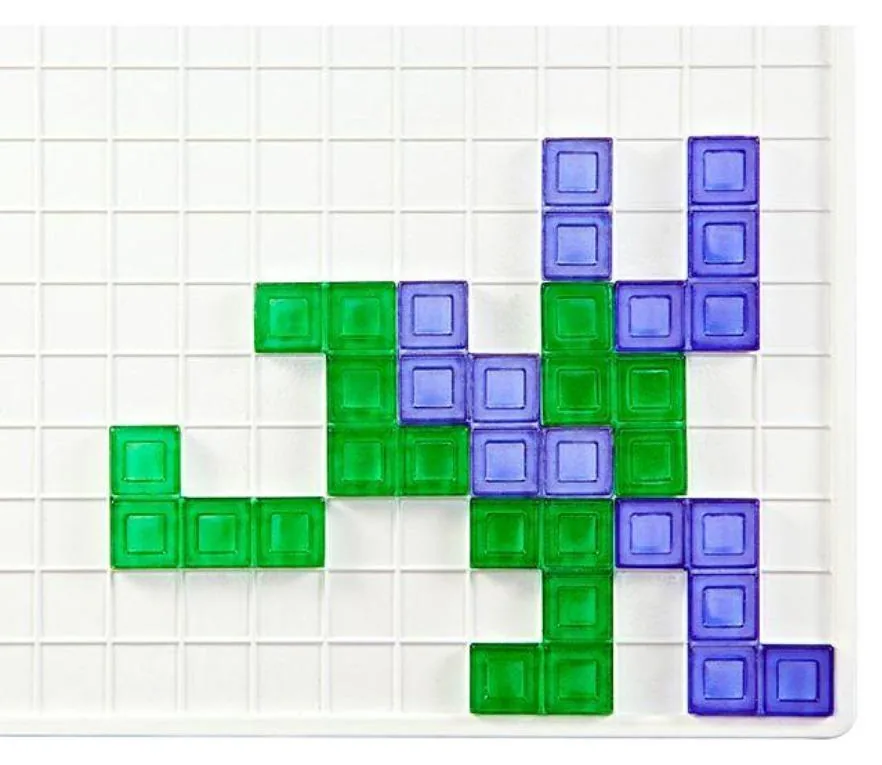 Close-up of green and blue Blokus pieces that touch only at their corners