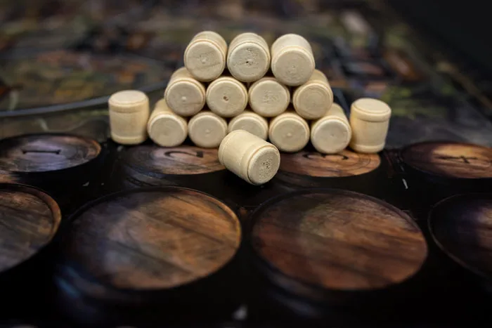 A pyramid of wooden beer barrels on the board