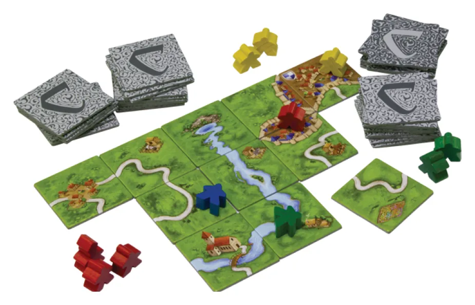 A small map of joined tiles with meeples on roads and cities, next to stacks of tiles