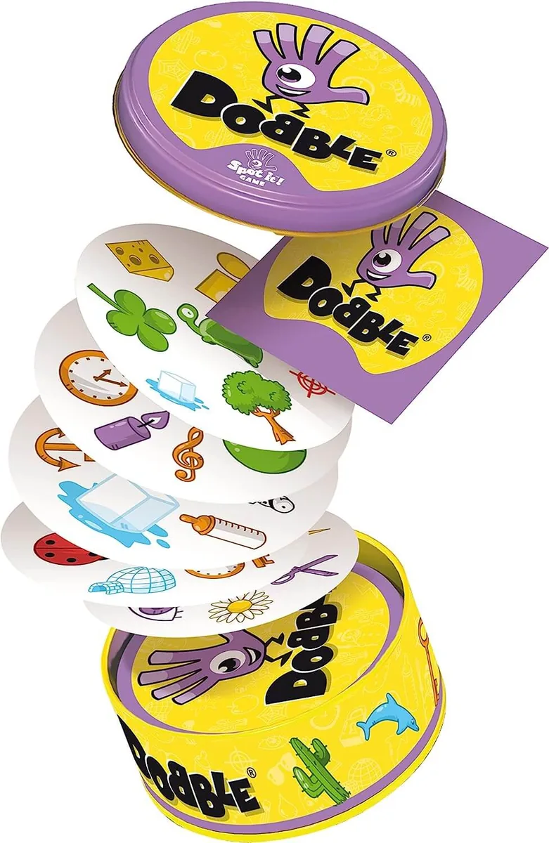 A stack of round Dobble cards rising out of the tin