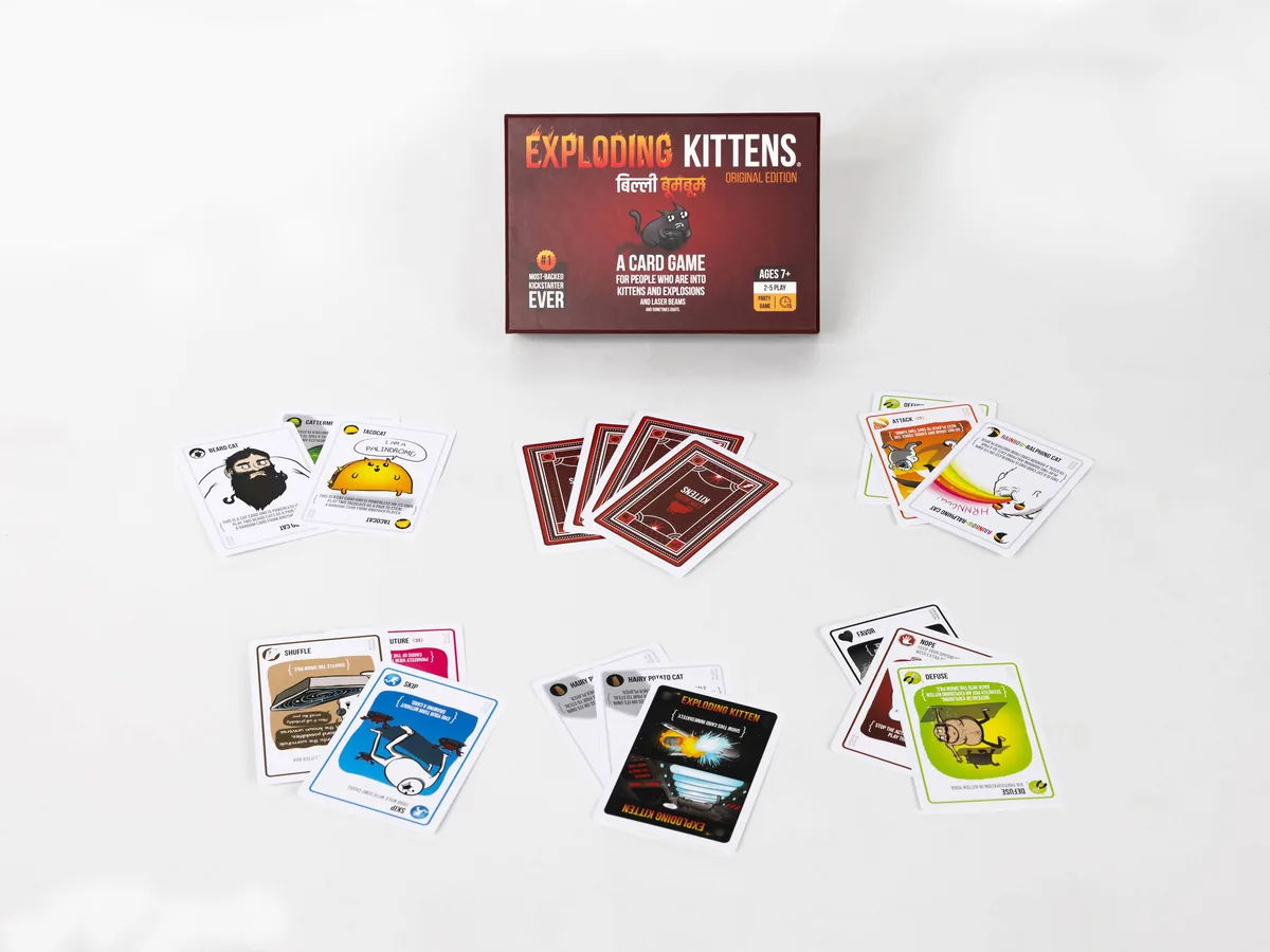 The box with cards laid out around it: Exploding Kitten, Defuse, action and cat cards