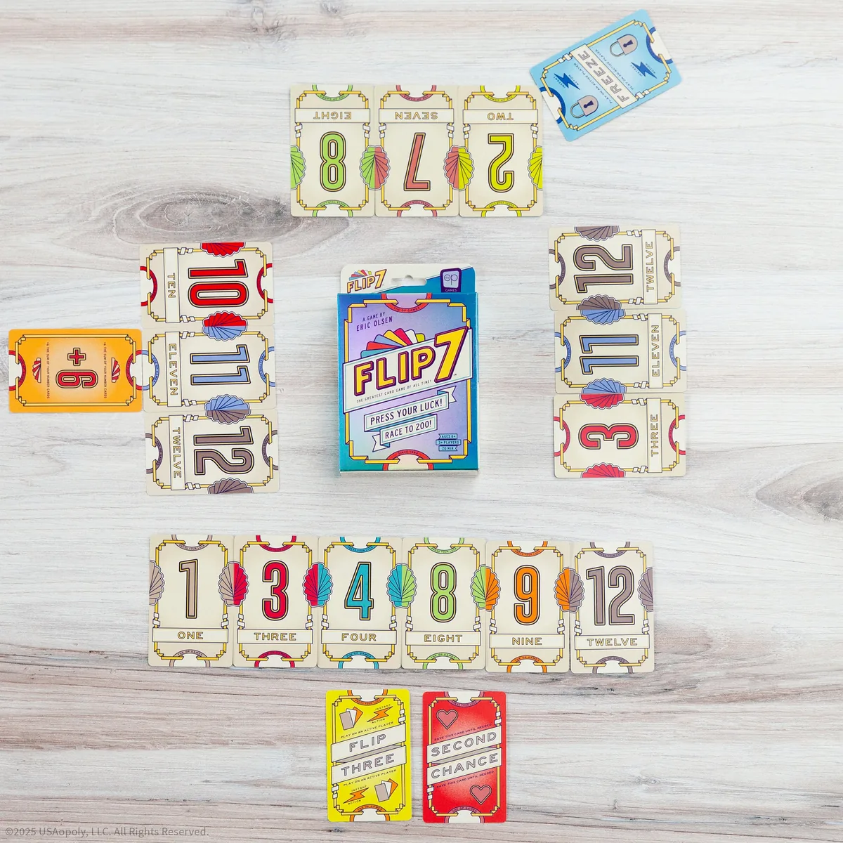 Flip 7 number cards laid out in rows on a table, with action cards beside them