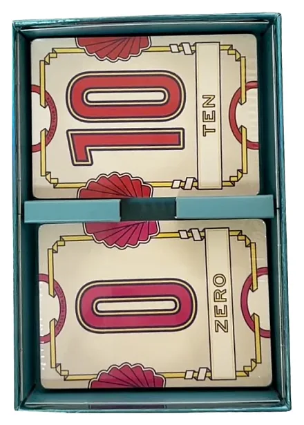 The inside of a Flip 7 box holding a stack of cards, with a red 10 and a 0 on top