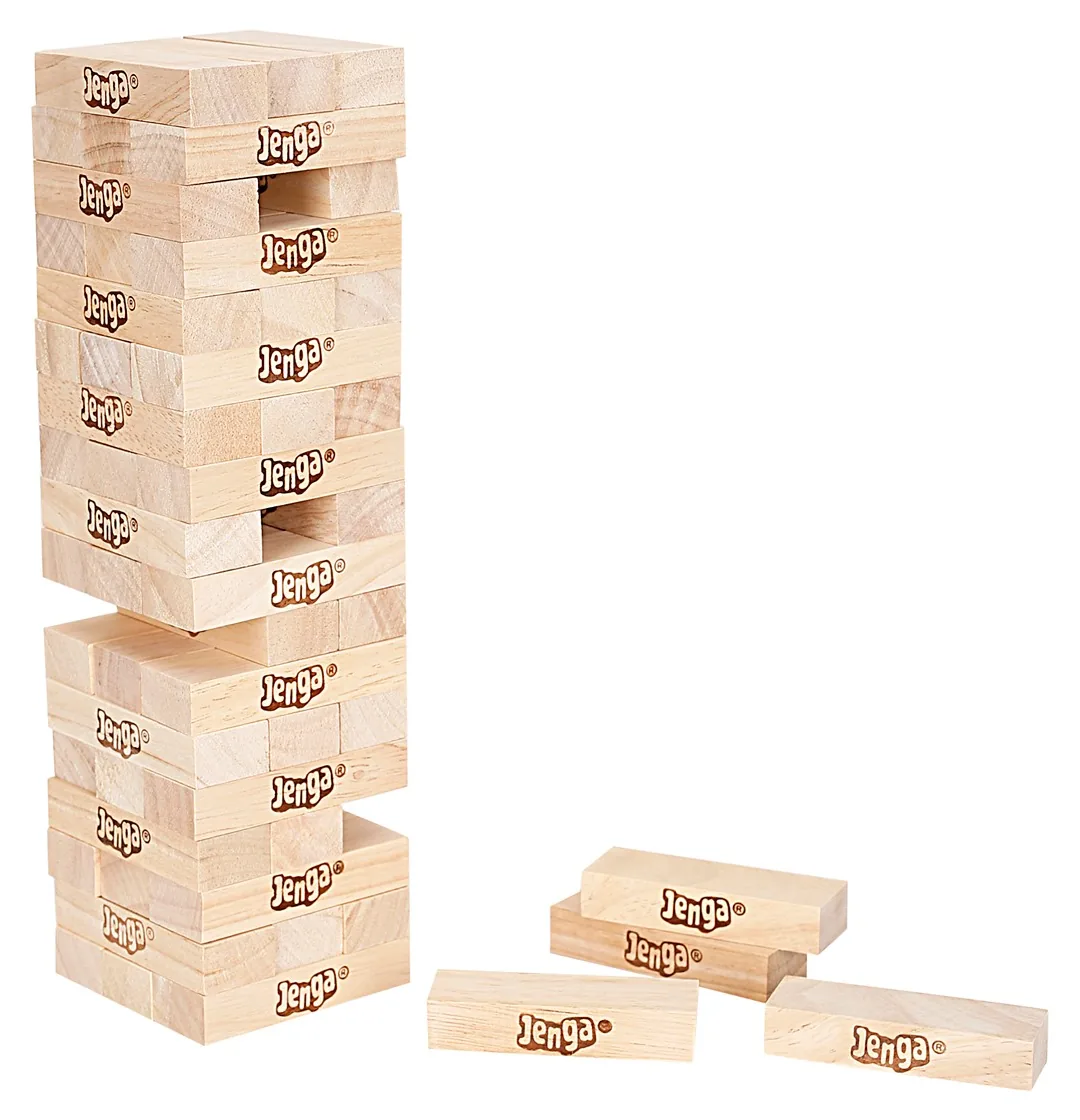 A Jenga tower with gaps where blocks have been pulled, and three blocks lying beside it
