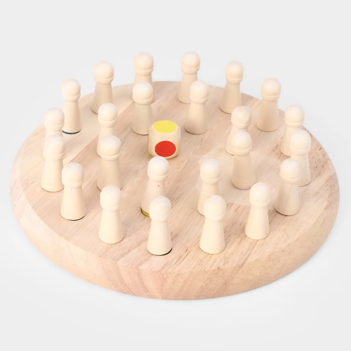 A round wooden memory chess board with plain wooden pegs in its holes and a colour die in the middle