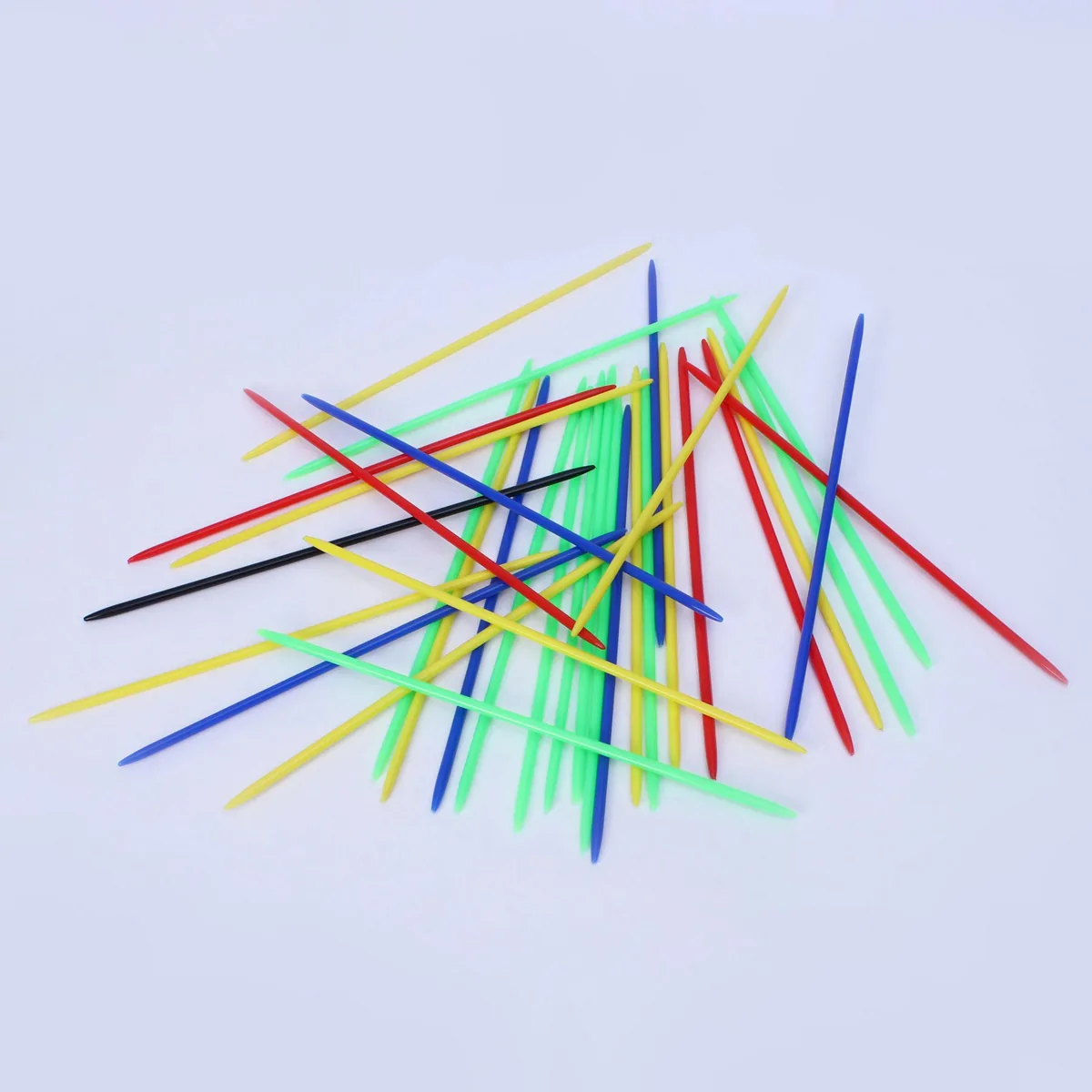 Ratna's plastic Mikado sticks in bright colours scattered on a pale background