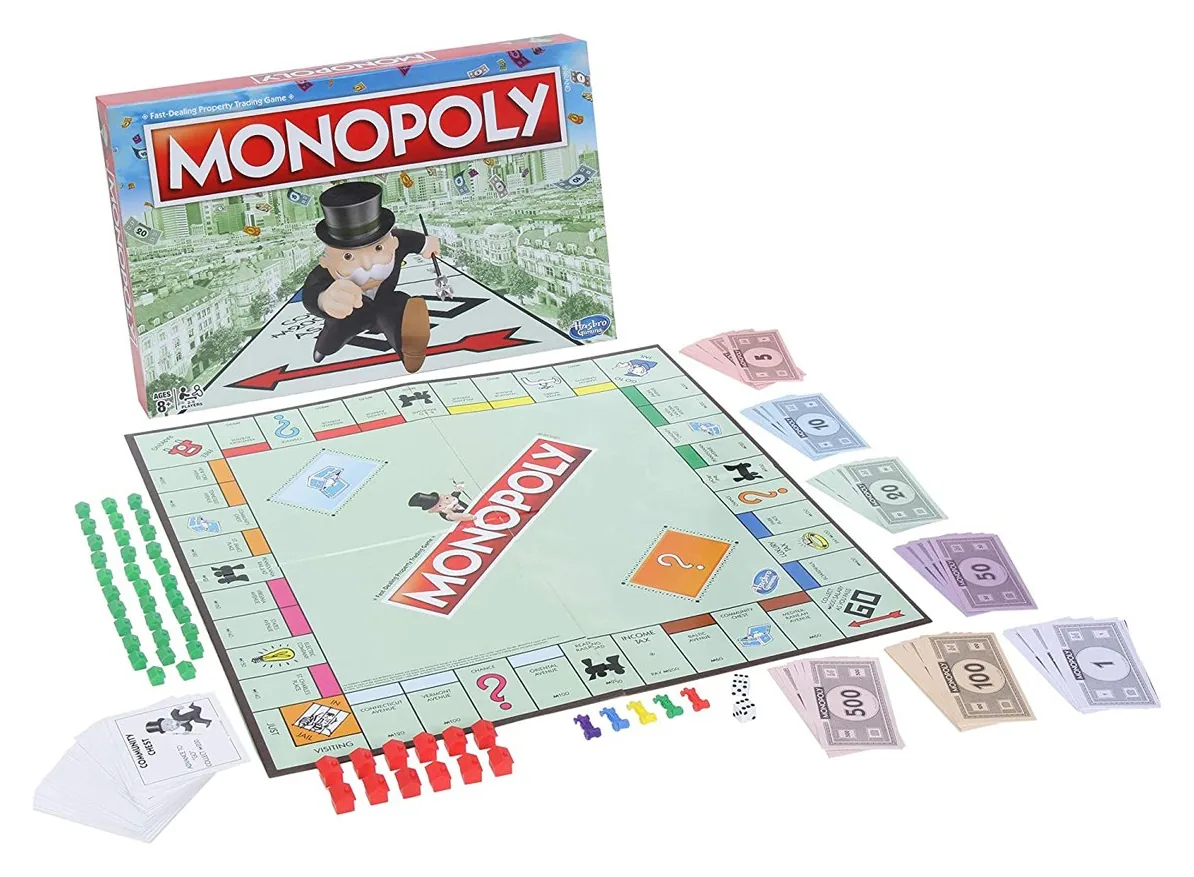 The classic Monopoly box with the board, money, cards, houses, hotels and tokens laid out in front