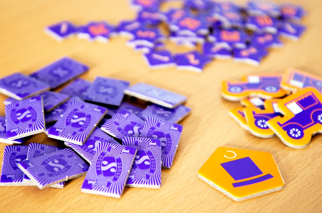 A pile of purple Scout chips with an orange Scout & Show chip on a table