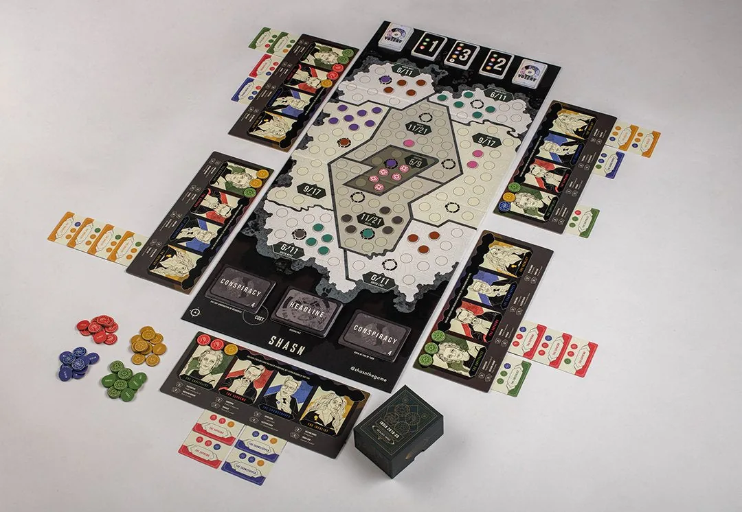 SHASN set up on a table: the board of zones in the middle, player mats around it, resource tokens and the card decks