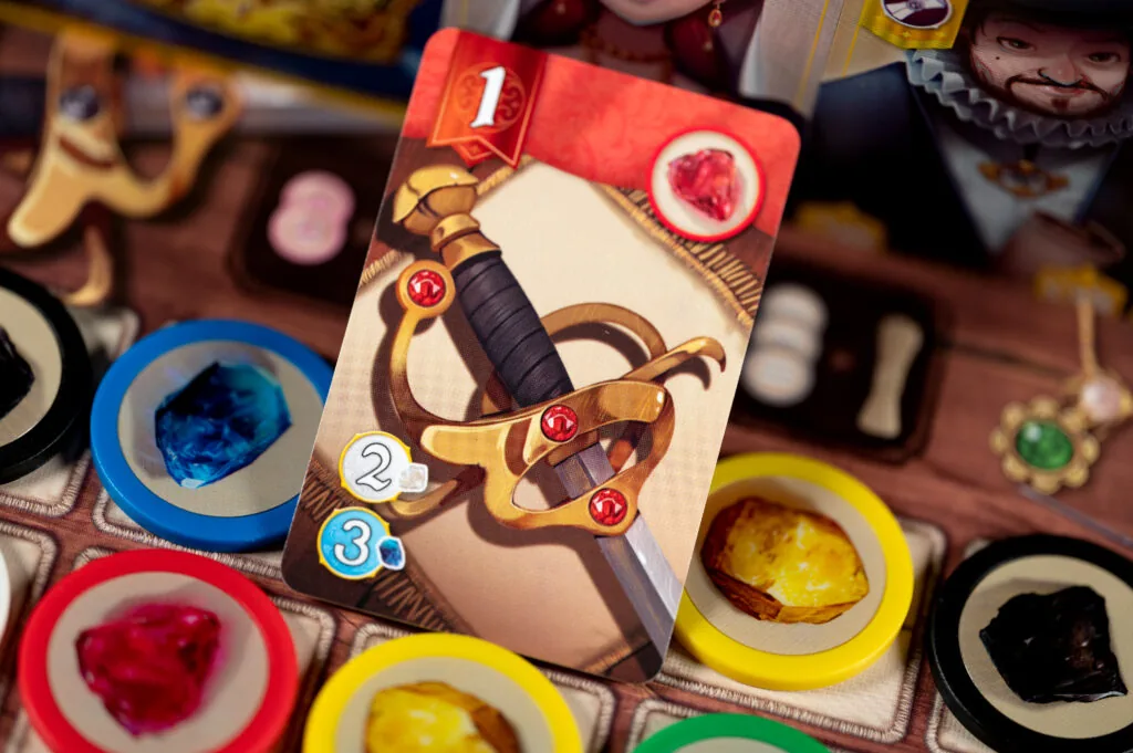 A level-1 jewel card resting on the gem board among blue, red, yellow and black tokens