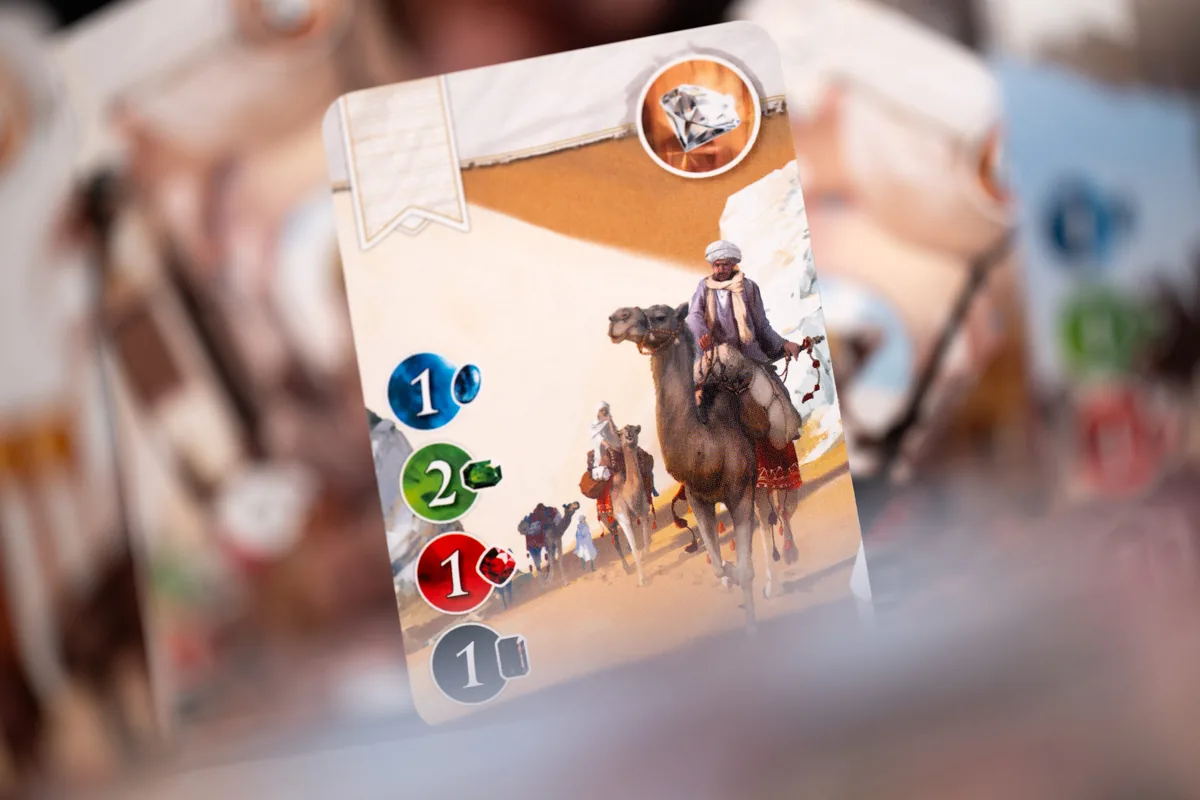 A card showing a camel caravan, with its gem cost printed down the side