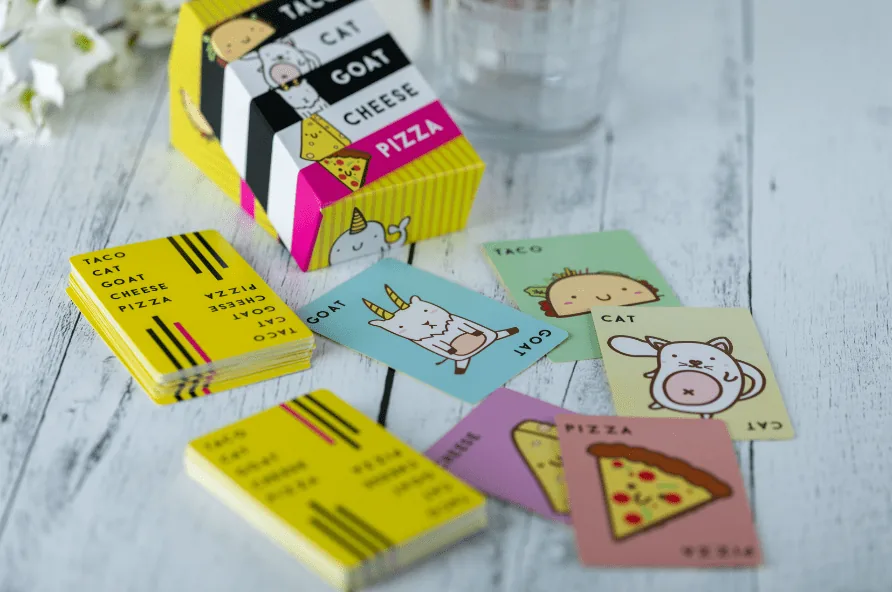 A Taco Cat Goat Cheese Pizza pack with taco, cat, goat, cheese and pizza cards spread out