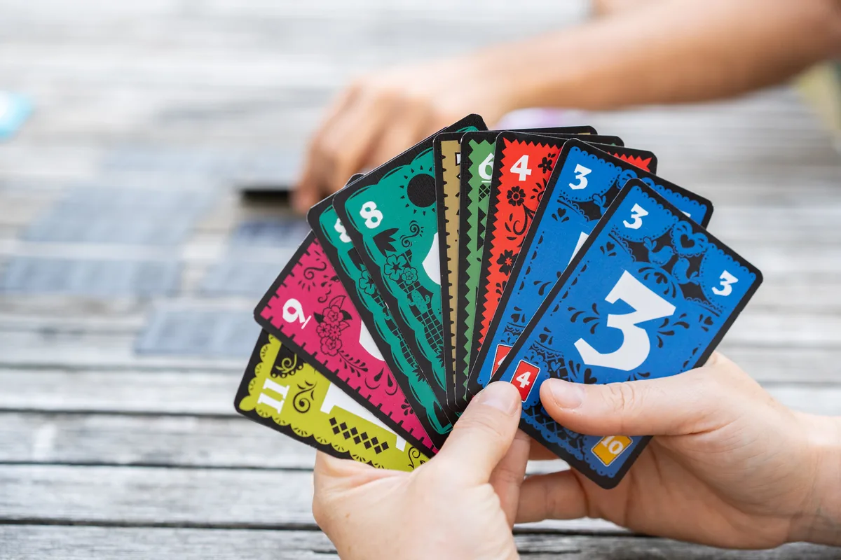 A player holding a sorted hand of Trio cards, numbers running from low to high