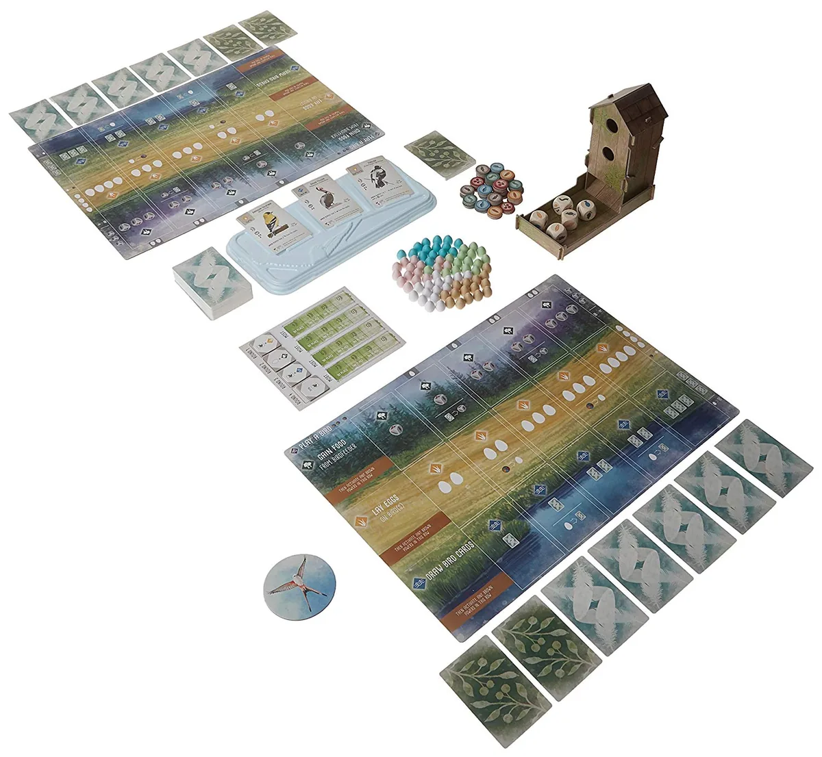 Wingspan's contents laid out: player mats, bird cards, egg miniatures, food tokens, dice and the birdhouse dice tower